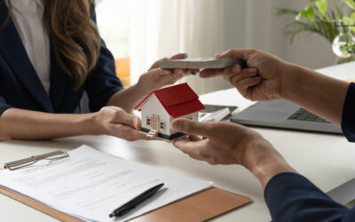 Real estate transaction with model house and documents in Dallas-Fort Worth area.